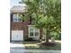 Charming brick townhome featuring a one-car garage and well-maintained front yard at 1909 Whirlaway Ct., Cary, NC 27519