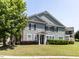 Inviting two-story home with gray siding, brown shutters, and a lush front lawn at 1909 Whirlaway Ct., Cary, NC 27519