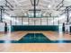 Spacious gymnasium with high ceilings, basketball hoops, and polished hardwood floors at 1909 Whirlaway Ct., Cary, NC 27519