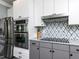 Close-up of kitchen featuring stainless steel appliances and decorative backsplash at 1909 Whirlaway Ct., Cary, NC 27519