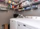 This laundry room has overhead shelving, a washer and dryer, and convenient storage solutions at 1909 Whirlaway Ct., Cary, NC 27519