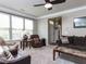 Comfortable living area with plush seating, ceiling fan, and plenty of natural light at 1909 Whirlaway Ct., Cary, NC 27519