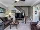 Inviting living room with plush sofa, accent chair, and staircase access at 1909 Whirlaway Ct., Cary, NC 27519