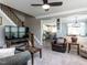 Cozy living room with staircase, modern furnishings, and neutral color scheme at 1909 Whirlaway Ct., Cary, NC 27519