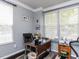 Bright office space with neutral walls, crown moulding, and a large window with a bench seat at 1909 Whirlaway Ct., Cary, NC 27519