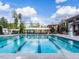 Beautiful swimming pool with lap lanes, lounge area, and lifeguard stand on a sunny day at 1909 Whirlaway Ct., Cary, NC 27519