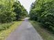 Well-maintained walking trail surrounded by lush trees and greenery, offering a peaceful outdoor experience at 1909 Whirlaway Ct., Cary, NC 27519