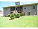 Back exterior view of a brick home with a screened porch and well-kept landscaping at 197 W Paige Wynd Dr, Angier, NC 27501