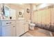 Bathroom with a white vanity, toilet, and shower featuring a leaf-patterned curtain at 197 W Paige Wynd Dr, Angier, NC 27501