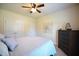 This bedroom includes a ceiling fan, closet and a dark wood dresser at 197 W Paige Wynd Dr, Angier, NC 27501