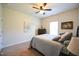 This bedroom features carpet, light colored walls, a ceiling fan and a comfortable looking bed at 197 W Paige Wynd Dr, Angier, NC 27501