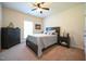 Bedroom featuring a dark wooden bed, light colored walls and a ceiling fan at 197 W Paige Wynd Dr, Angier, NC 27501