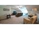 Bonus room with carpeting, ceiling fan, and furnishings for relaxation and entertainment at 197 W Paige Wynd Dr, Angier, NC 27501