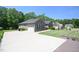 View of the home's driveway and attached two-car garage at 197 W Paige Wynd Dr, Angier, NC 27501