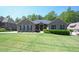 Charming brick home featuring a manicured lawn and lush landscaping at 197 W Paige Wynd Dr, Angier, NC 27501