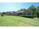 Well-manicured front yard with a charming brick home and lush green lawn at 197 W Paige Wynd Dr, Angier, NC 27501