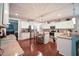 Bright, open kitchen with white cabinets, granite countertops, stainless steel appliances, and hardwood floors at 197 W Paige Wynd Dr, Angier, NC 27501