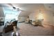 An attic living room with neutral carpet, a sofa, and ceiling fan lighting at 197 W Paige Wynd Dr, Angier, NC 27501