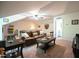 Inviting living room with leather sofa, golf putting mat and access to bath at 197 W Paige Wynd Dr, Angier, NC 27501