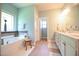 The main bathroom features a soaking tub, a window, light green walls and decorative accent pieces at 197 W Paige Wynd Dr, Angier, NC 27501