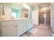 This main bathroom features double sinks, white cabinets, and a tiled glass enclosed shower at 197 W Paige Wynd Dr, Angier, NC 27501