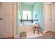 The main bathroom features a soaking tub with tiled backsplash, a window, and light green walls at 197 W Paige Wynd Dr, Angier, NC 27501