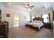 Spacious main bedroom boasts a tray ceiling, plush carpeting, and ensuite access at 197 W Paige Wynd Dr, Angier, NC 27501