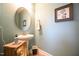 This powder room features a pedestal sink, a decorative mirror and beach themed decorations at 197 W Paige Wynd Dr, Angier, NC 27501