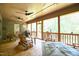 Expansive screened porch featuring a dining set, comfortable seating, and views of the surrounding greenery at 197 W Paige Wynd Dr, Angier, NC 27501