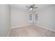 Bedroom with neutral paint, carpet, ceiling fan and two windows at 2014 Silky Dogwood Trl, Apex, NC 27502