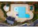 Aerial view of the community pool, diving board, baby pool, lounge chairs, covered seating, and pool house at 2014 Silky Dogwood Trl, Apex, NC 27502