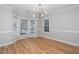 Bright dining room featuring modern light fixture, hardwood floors, and a large bay window offering ample natural light at 2014 Silky Dogwood Trl, Apex, NC 27502