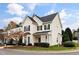 Charming two-story home featuring green shutters, well-manicured landscaping and a beautiful tree in the front yard at 2014 Silky Dogwood Trl, Apex, NC 27502