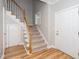 Bright foyer showcasing hardwood floors and a carpeted staircase, leading to the upper level of the home at 2014 Silky Dogwood Trl, Apex, NC 27502