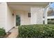 Welcoming front porch featuring a decorative lattice panel and a well-maintained shrub, hinting at a cozy entrance at 2014 Silky Dogwood Trl, Apex, NC 27502
