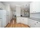 Bright kitchen featuring stainless steel appliances, tile backsplash and wood floor at 2014 Silky Dogwood Trl, Apex, NC 27502