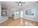Inviting living area featuring hardwood floors, a ceiling fan, an attached kitchen, and plenty of natural light at 2014 Silky Dogwood Trl, Apex, NC 27502