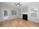 Bright living room features hardwood floors, a cozy fireplace, and access to a back patio, perfect for relaxing at 2014 Silky Dogwood Trl, Apex, NC 27502