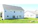 Spacious backyard with light gray vinyl home exterior and ample open green space at 202 Redstone Ct, Gibsonville, NC 27249