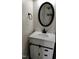 Bathroom vanity with dark hardware and black framed mirror at 202 Redstone Ct, Gibsonville, NC 27249