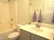 Bright bathroom featuring a tub and shower combo, mirrored vanity, and neutral finishes at 202 Redstone Ct, Gibsonville, NC 27249
