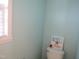 Blue bathroom with a toilet, starfish art, and a shuttered window at 202 Redstone Ct, Gibsonville, NC 27249