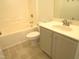 Bathroom features a vanity with storage and a combined tub and shower at 202 Redstone Ct, Gibsonville, NC 27249