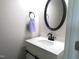 A cute bathroom featuring an oval mirror, vanity with storage, and a towel rack at 202 Redstone Ct, Gibsonville, NC 27249