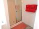 Bright bathroom featuring a shower with glass doors and orange towels on a rack at 202 Redstone Ct, Gibsonville, NC 27249
