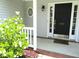 Inviting front entrance with a black door and decorative accents at 202 Redstone Ct, Gibsonville, NC 27249