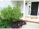 Charming front entrance with a well-maintained garden and welcoming door at 202 Redstone Ct, Gibsonville, NC 27249