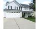 Charming two-story home with a two-car garage and well-maintained landscaping, perfect for Gathering living at 202 Redstone Ct, Gibsonville, NC 27249