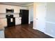 Well-lit kitchen features white cabinets, black appliances, and modern countertops at 202 Redstone Ct, Gibsonville, NC 27249