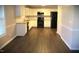 Bright kitchen with white cabinets, granite countertops, stainless steel appliances, and new flooring throughout at 202 Redstone Ct, Gibsonville, NC 27249